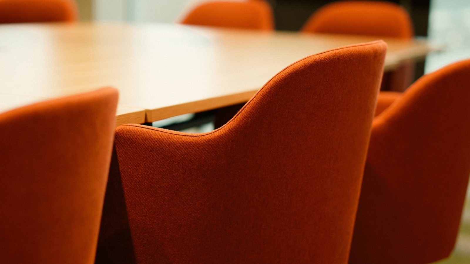 Empty boardroom seating arranged before a meeting begins.