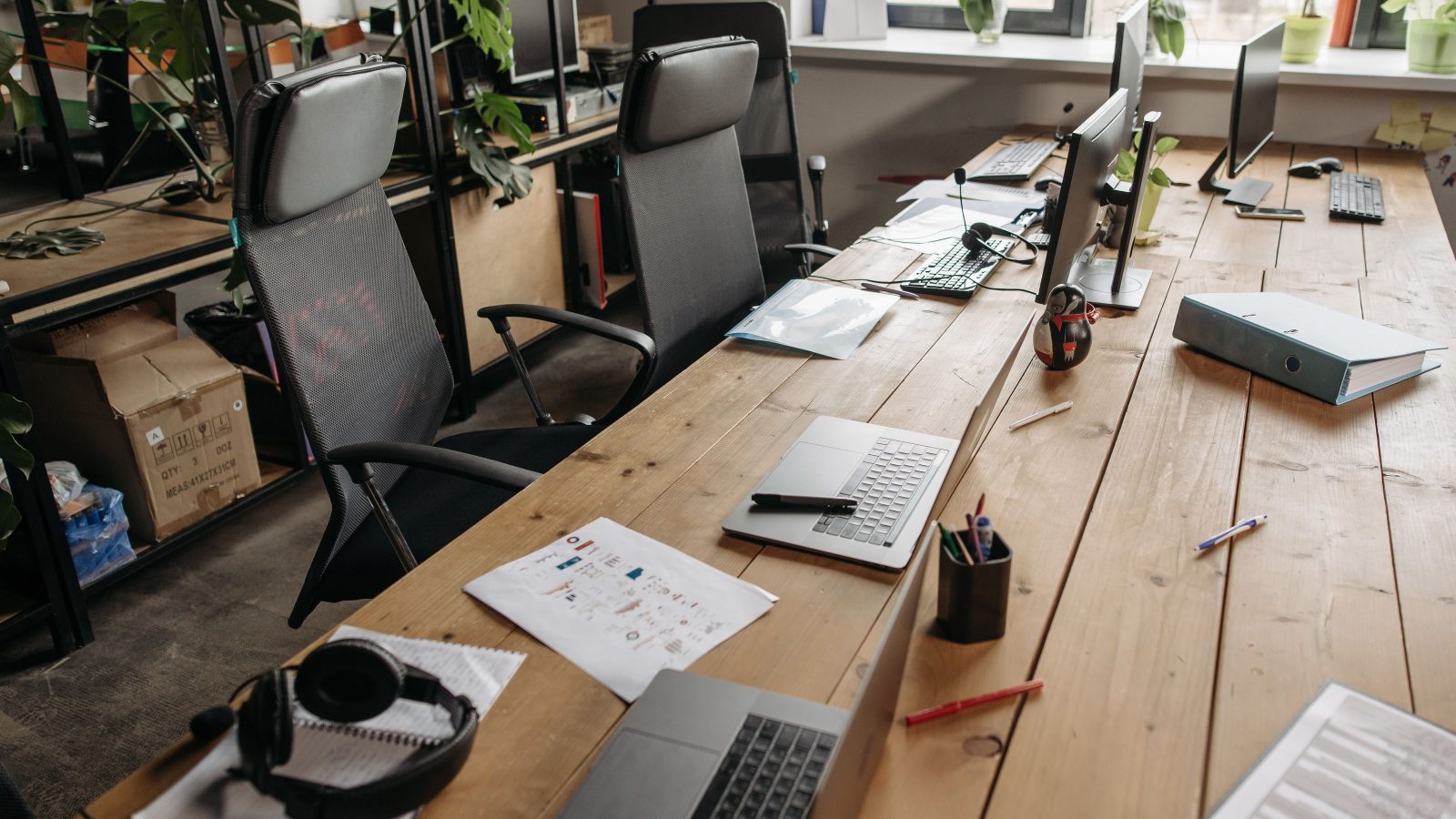 Row of empty desks in a quiet office representing available organisational capacity.